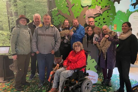 Besuchergruppe in der Ausstellung der Wildkatzenscheune (Werkstattbeschäftige des dbi)